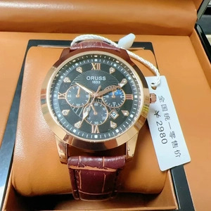 Detail of luxury men's watch with rose gold case and leather strap in an elegant gift box