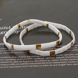 Bohemian Tila bead bracelets featuring white ceramic and gold square tiles in a set