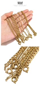 Detailed macro of gold-plated stainless steel curb, paperclip, and bead chains