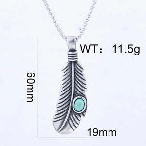 Detail view of retro feather pendant with turquoise stone and fine engraved textures