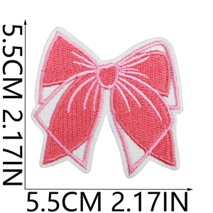 Macro detail of pink embroidered bow patch showing precise 5.5cm dimensions on white background