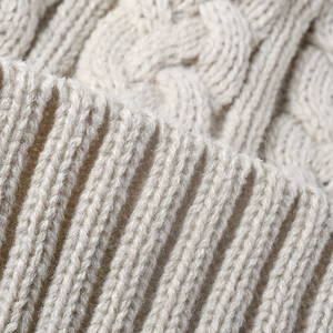 Women's warm cable knit outdoor beanie with thick fleece lining in creamy white