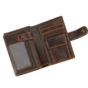 Detail view of brown leather wallet interior showing card slots and snap coin pocket