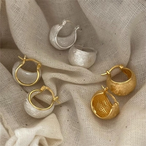 Three pairs of vintage brushed 925 silver hoop earrings in gold and silver finishes