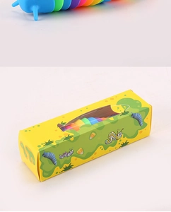 Close-up of colorful sensory slug toy with its yellow cartoon display packaging box