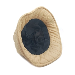 Padded winter bucket hat with diamond quilted pattern in champagne gold nylon