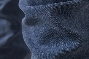 Close-up of premium dark blue denim fabric texture and durable cotton twill weave