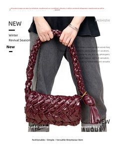 Macro shot of burgundy oil wax leather woven shoulder bag with fringe and metal ring detail