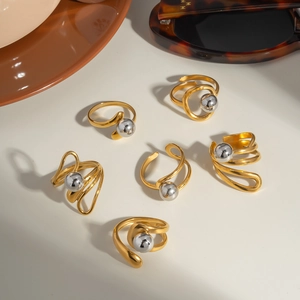 Minimalist stainless steel ring set with gold bands and silver beads in a 6-piece display