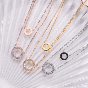Detailed view of layered 18K gold plated necklaces in rose gold, gold, and silver finishes