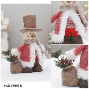 Detail of Christmas snowman figurine with red wool coat, hat and pine cone bag accessory
