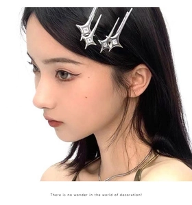 Detail of silver Y2K star hair clips with white zircons worn on a model side view