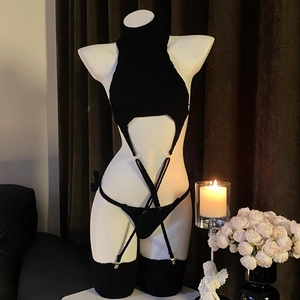 Detailed view of black ribbed knit lingerie set including high neck top and stockings