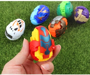 Close-up of a colorful dinosaur transformation egg toy held by hand outdoors
