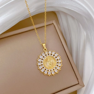 Macro view of gold portrait pendant with sparkling crystal halo on stainless steel chain