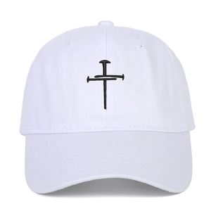 White cotton baseball cap with black cross nail embroidery and curved brim in 45-degree view