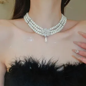Three-layer pearl necklace set with rhinestone flower charm and teardrop pearl drop