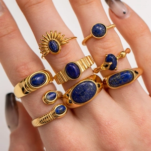 Macro shot of vintage gold rings set with lapis lazuli stones on a model hand