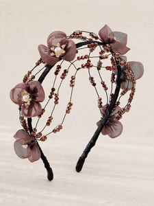 Detail of handmade floral beaded headband with purple mesh petals and crystal beads