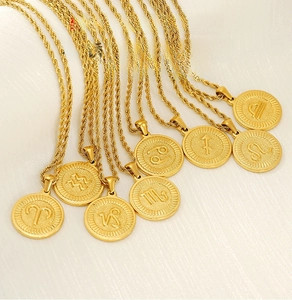 Detailed macro of 18k gold plated stainless steel zodiac necklaces with rope chain