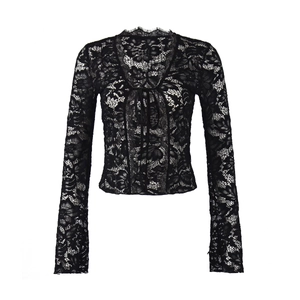 Detailed close-up of black floral lace fabric and front tie design on a cropped cardigan