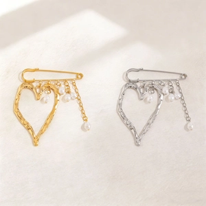 Exaggerated liquid lava heart brooch with pearls in gold and silver finish
