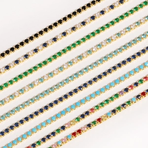 Close-up of gold-plated bracelets featuring rows of vibrant multi-colored zircon stones
