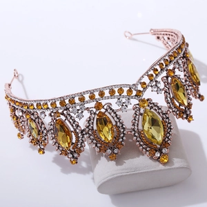Detailed close-up of Baroque bridal crown with large yellow crystals and golden filigree