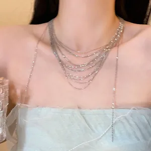 Detail of multi-layered silver tassel necklace showing delicate metal chain drape