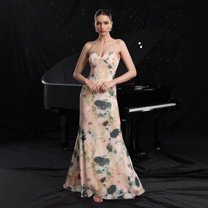 Detail of elegant V-neck printed floral maxi dress with thin straps by a piano
