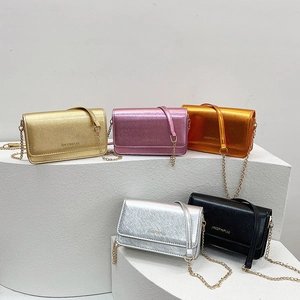 Mini metallic chain square bags in five colors displayed on white geometric stands