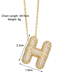 Detail of gold-tone H pendant necklace with dimensions 2.2cm by 1.8cm and cubic zirconia