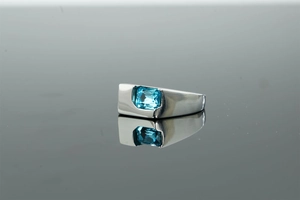 Detailed side view of a wide silver ring featuring a rectangular blue zircon stone