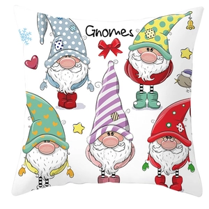 Macro detail of five colorful Christmas gnomes printed on a white pillowcase cover