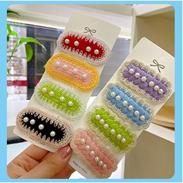 Handmade crochet hair clips with colorful knit edges and small white bead accents
