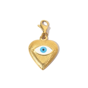 Detailed view of heart-shaped gold pendant with blue evil eye charm and lobster clasp