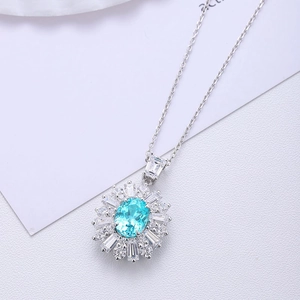 Luxurious S925 silver necklace with sun-shaped pendant and oval blue gemstone