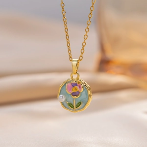 Golden flower necklace with blue enamel and pearl pendant on soft beige silk