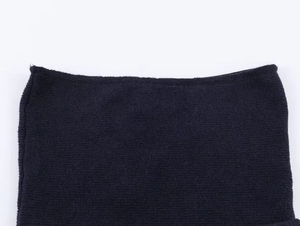 Close-up of high-quality knitted fabric texture and fine hem stitching on black top