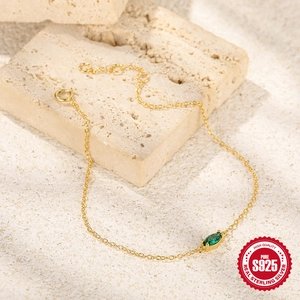 Detail of a 925 silver gold-plated bracelet with an elegant marquise green zircon stone