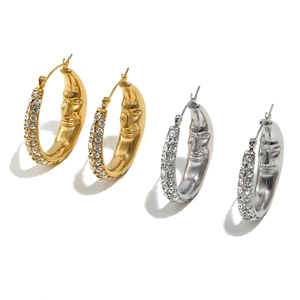Detailed macro view of 18K gold and silver plated moon face earrings with zircons