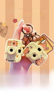 Detail of cute Capybara camera keychain with glowing light effect and cartoon design