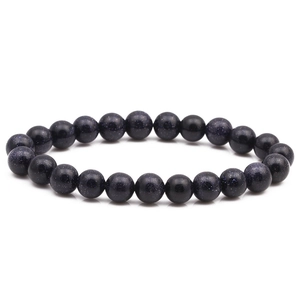 Macro shot of 8mm blue goldstone beaded bracelet with shimmering starry sky effect