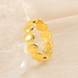 Detailed view of adjustable golden shell ring with polished scalloped metal edges