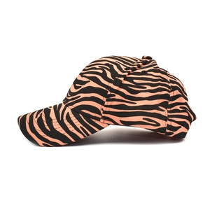Side view of trendy zebra print cotton baseball cap with orange and black contrast patterns