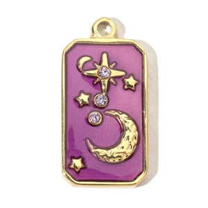 Detail of vintage star and moon gold pendant with purple enamel inlay and crystals