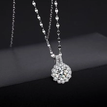 Macro detail of a silver sunflower pendant necklace with sparkling zirconia stones