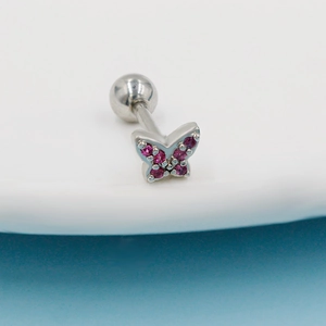 Macro view of butterfly stud piercing with pink zircon stones and round ball back screw