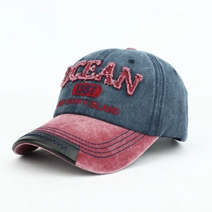 Vintage wash baseball cap with OCEAN embroidery and red brim in a retro outdoor style