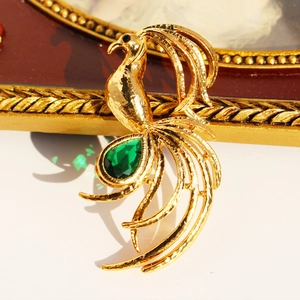 Golden phoenix brooch with peacock tail zircon and green pear-shaped gemstone for suits